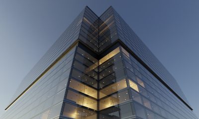Low angle view of generic modern office skyscrapers ,high rise buildings with glass facades . Concepts of finances and economics background. 3d rendering .