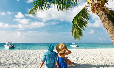 Couple in blue clothes on a tropical beach at Maldives