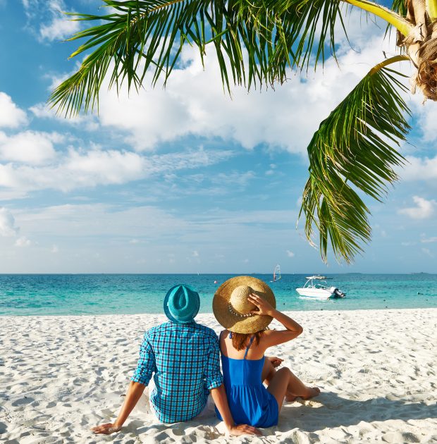 Couple in blue clothes on a tropical beach at Maldives
